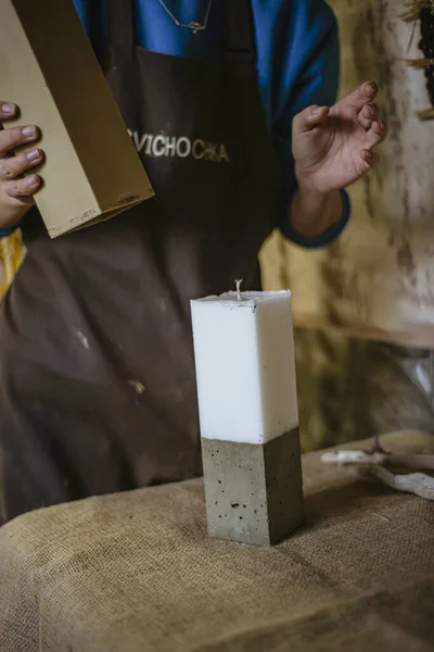 the process of making a rectangular candle from cement, small business concept at home, taking out a large candle from a rectangular shape