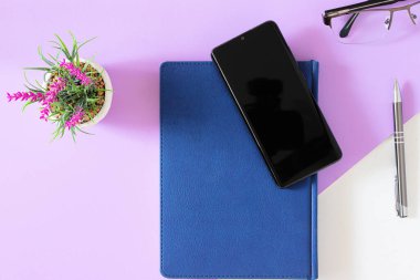 mobile phone organizer and pen concept taken on desktop