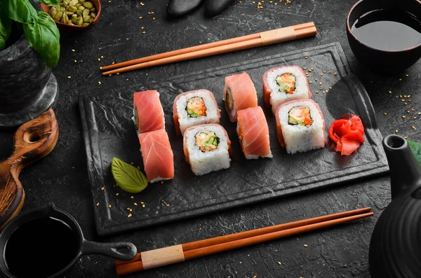 Sushi rolls with tuna and night stone plate. Top view.