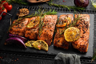 Baked Salmon with rosemary, lemon and vegetables. Recipe. Seafood. Side view Free space for text. clipart