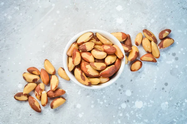 Nuts. Brazil nut on a stone background. Top view. Free space for text.