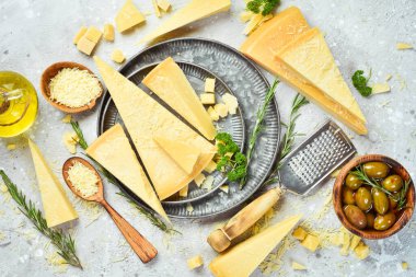 Dairy products. Parmesan cheese in a bowl on a stone table. Top view. On a concrete background.
