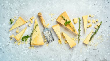 Cheese background. Triangular pieces of hard cheese on a stone background. Parmesan. Free space for text.