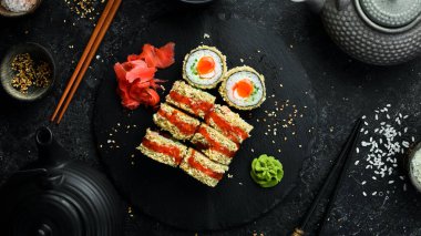 Sushi rolls on a stone plate. Close-up. Japanese food.