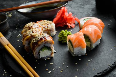 Traditional sushi rolls on a stone plate. Close-up. Sushi menu. Japanese food.