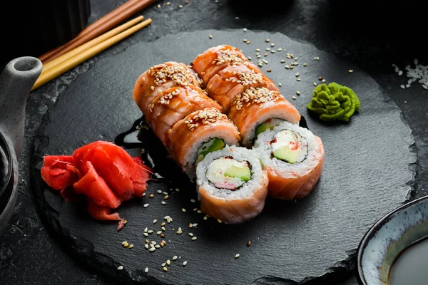 Traditional sushi rolls on a stone plate. Close-up. Sushi menu. Japanese food.