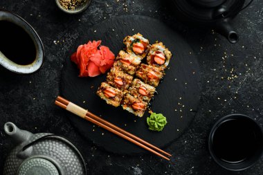 Delicious Sushi rolls with eel. Traditional Japanese food. On a black stone plate.