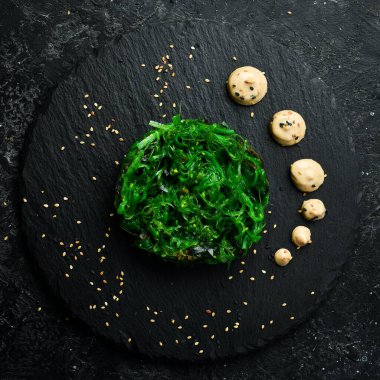 Chuka seaweed salad. Foods high in iodine. On a black stone plate.