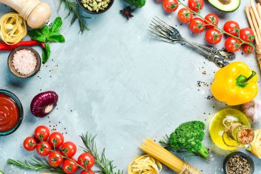 Food background. Fresh vegetables on a gray stone background. Top view. Free space for text.
