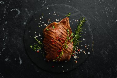 Izgara mermer biftek filetosu. Siyah taştan bir arka planda.