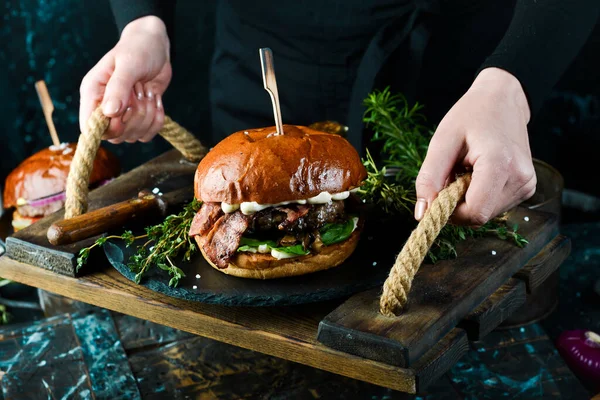베이컨 야채를 곁들인 맛있는 햄버거 어두운 배경에서 패스트푸드의 — 스톡 사진