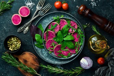 Sebze diyet salatası: ıspanak, karpuz turpu, siyah susam ve zeytinyağı. Vejetaryen yemeği. Üst Manzara. Taş bir arka planda.