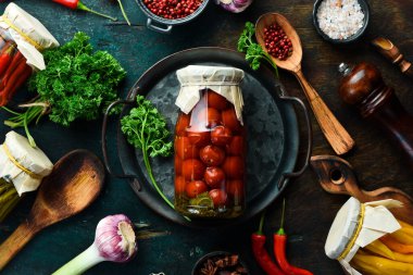 Cam kavanozda ev yapımı vişneli domates turşusu. Yiyecek malzemeleri. Üst görünüm.