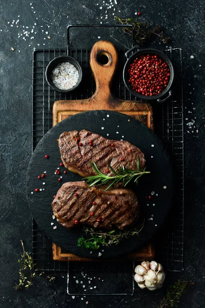 Two Juicy Rib Eye Steak Herbs Spices Black Stone Background — Stock Photo, Image