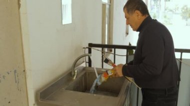 Sanatçı fırçaları yıkıyor