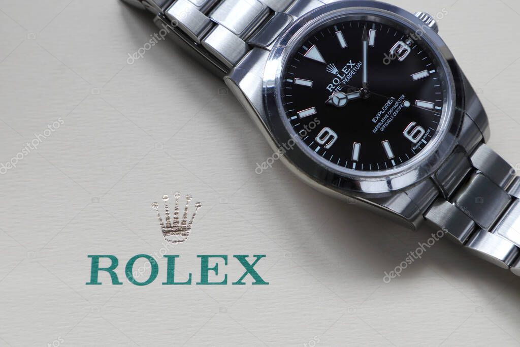 The Rolex wristwatch model oyster perpetual explorer I display on the ivory background of Rolex crown logo