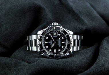 The Rolex vintage wristwatch ceramic bezel model black oyster perpetual submariner date 39 mm display on black table with black cloth in the luxury watch shop