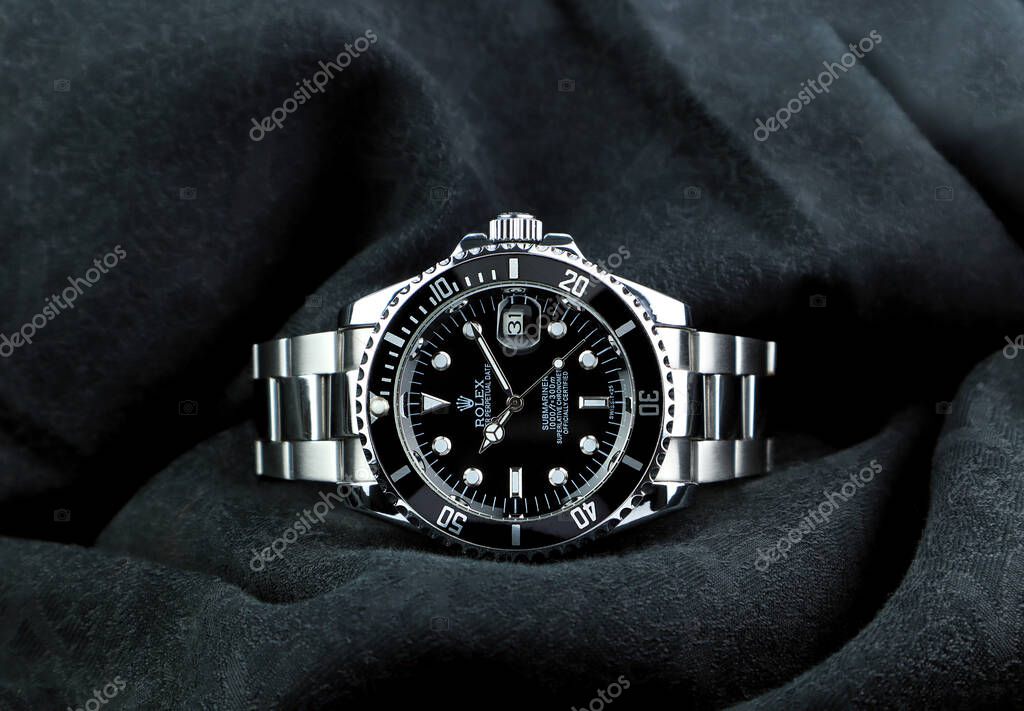 The Rolex vintage wristwatch ceramic bezel model black oyster perpetual submariner date 39 mm display on black table with black cloth in the luxury watch shop