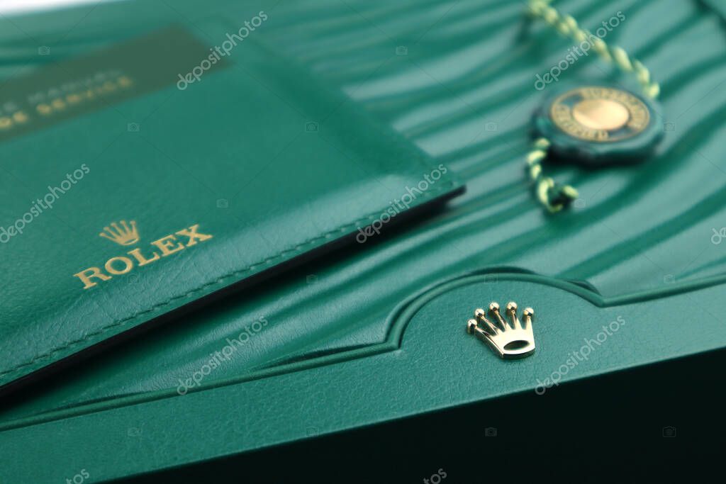 The Rolex package green leather box with golden logo is displayed  on the shelf in the luxury watch shop