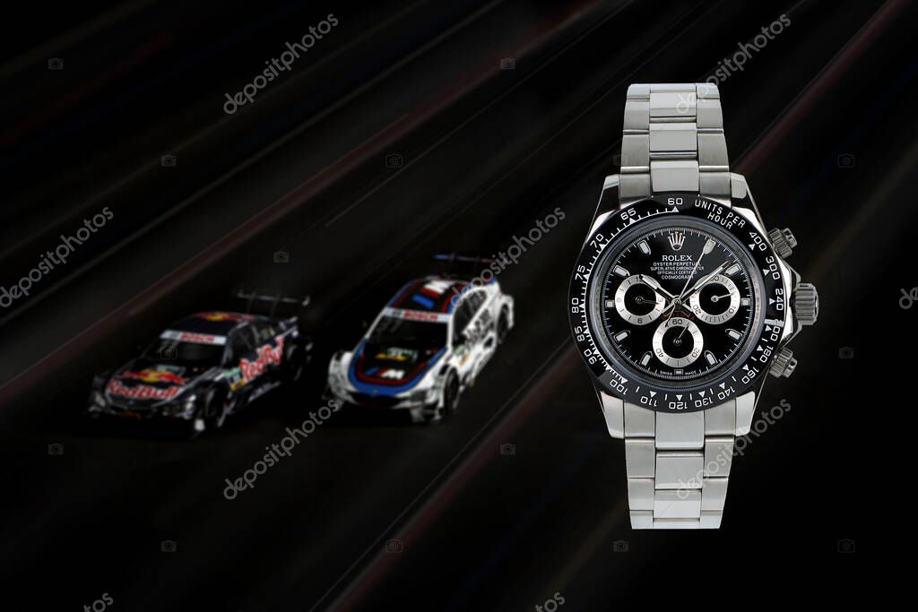 Rolex wristwatch model cosmograph daytona oyster perpetual superlative chronometer with black ceramic bezel stainless steel body with background of sports racing car daytona tournament grandprix