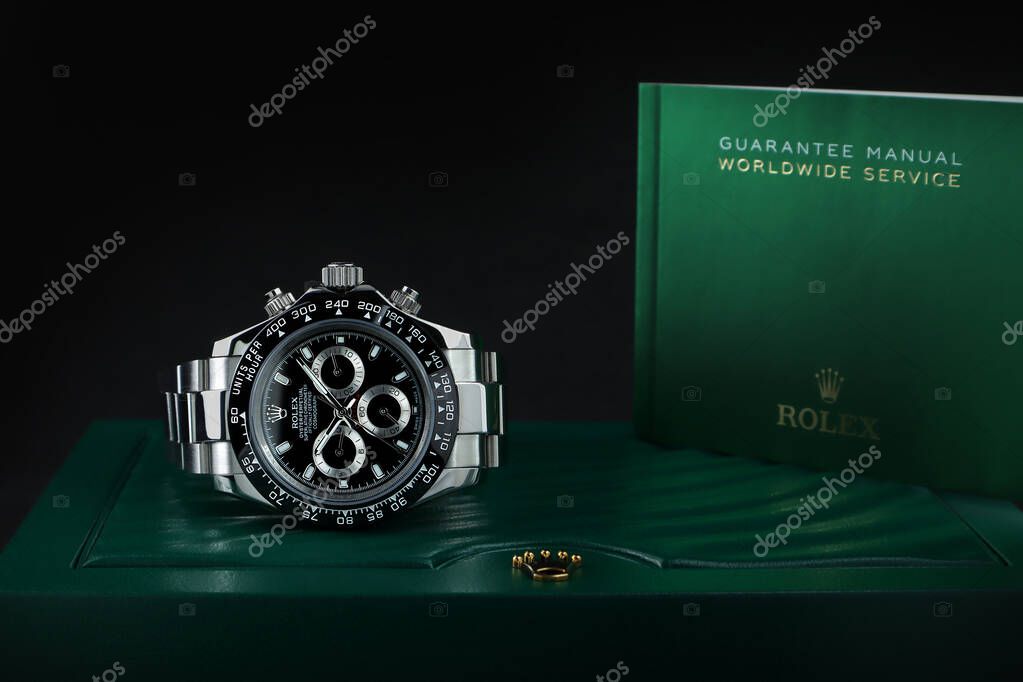 Rolex wristwatch model cosmograph daytona oyster perpetual superlative chronometer with black ceramic bezel stainless steel body on Rolex green box crown logo package with  worldwide guarantee manual