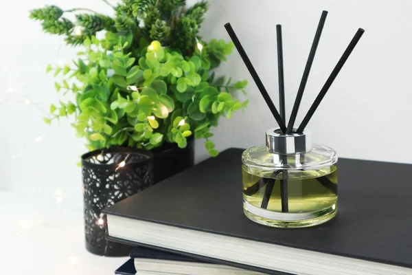 Luxury Aroma Scent Reed Diffuser Glass Bottle White Table Books — стоковое фото