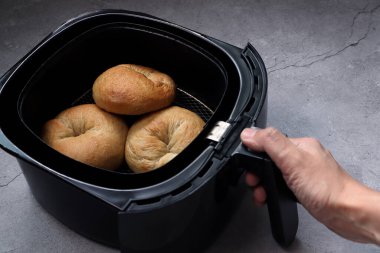 Ev yapımı organik bagel ekmeği, sabah kahvaltısı olarak siyah hava fritözü ya da yağsız fritöz kullanılarak pişirilir.