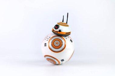 a droid robot character in the Star Wars movie name BB-8 (or Beebee-Ate) display on white table with background of white cement wall in the star war movie toy shop