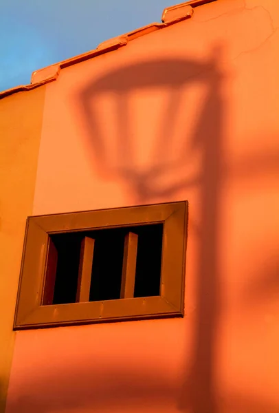 日没時の壁に街灯柱の影 — ストック写真