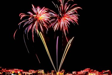Multicolored fireworks show on a summer night clipart