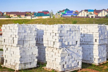 Smooth stacks of bricks in a package. Preparation for the construction of a house. Building materials.