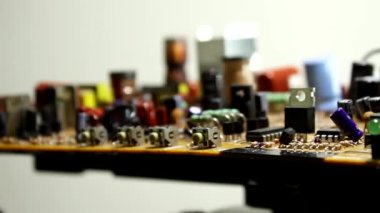Radio components on a computer board rotates closeup video