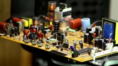 Video of electronic board closeup rotates on a machine stand