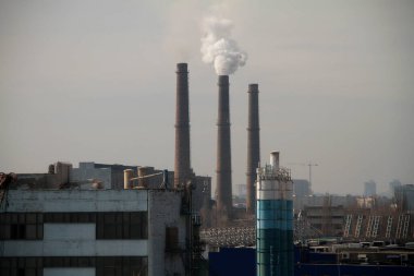 A large industrial plant on the outskirts of the city pollutes the environment with emissions from smokestacks