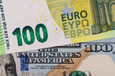 Fragment of banknotes in denominations of 100 euros and 100 US dollars