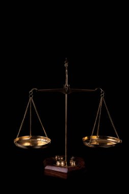 Gilded scales with two hanging bowls on a black background