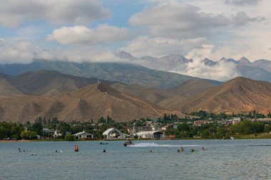 Cholpon Ata, Kyrgyzstan, 07.29.2022. The coast of Lake Issyk Kul against the backdrop of picturesque mountains