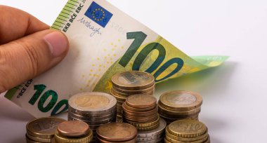 Euro coins and 100 euro banknote
