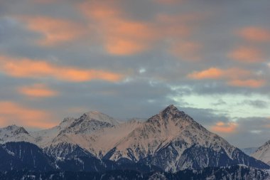 Snow-covered mountain range and picturesque early sky