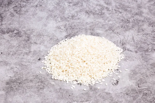 Pile White Rice Grains Gray Stone Background Oriental Healthy Food — Stockfoto