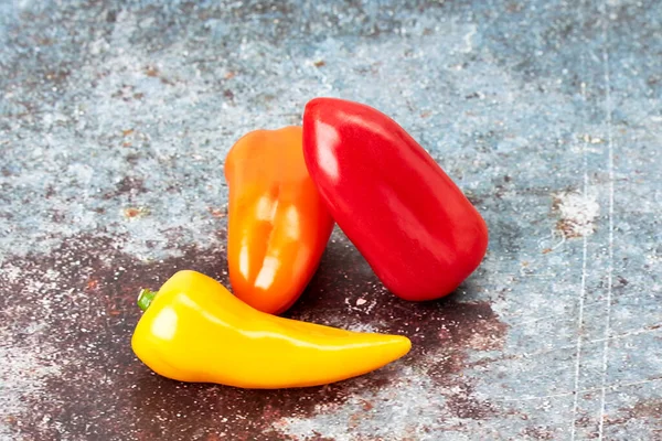 Three Small Red Yellow Orange Peppers Vegan Vegetarian Food Healthy — стоковое фото