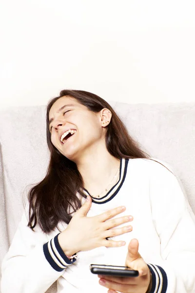 Cheerful girl receiving good news notification via cell phone, Internet success