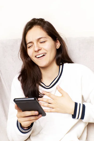 Cheerful girl receiving good news notification via cell phone, Internet success