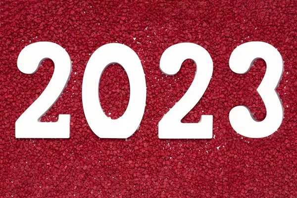 Number 2023 on small red stones. New Year and Christmas concept