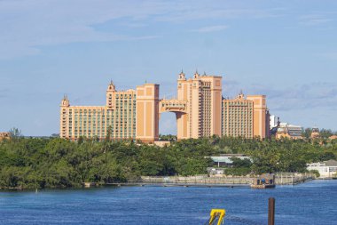 Panoramic view of Atlantis buildings in Nassau, The Bahamas, with blue skies near a coastline | Replica of Atlantis buildings in Nassau, Bahamas Image Background 
