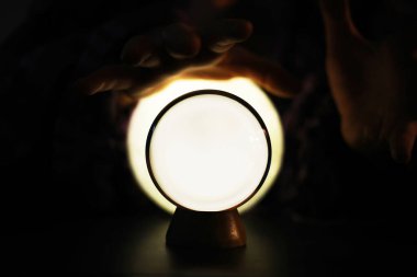 Yerde Bokeh 'le kristal küre var. Renkli ışık saçan cam top, yeni yıl kutlaması konsepti..