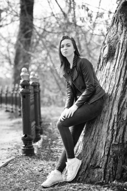 Bahar şehrinde güneşli bir havada yürüyen bir kız.