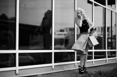 Küçük bir köpekle yürüyüşe çıkmış güzel bir sarışın.