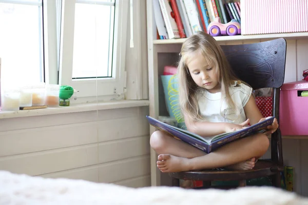 Küçük Kız Odada Oturuyor Kitap Okuyor — Stok fotoğraf