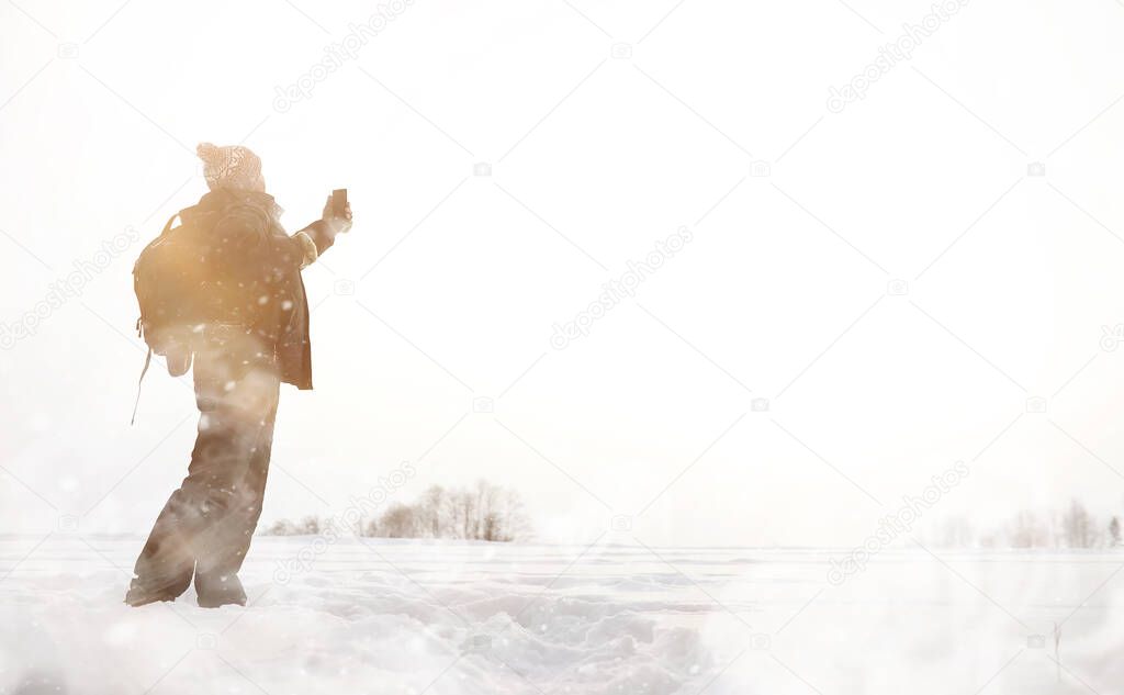 A man on a walk. Winter landscape. Tourist in the winter journey.